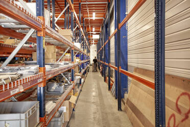 Man organizing the spare parts department in a boat building factory - CAVF64111