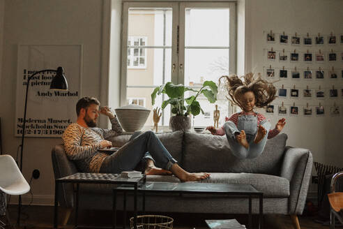 Father and daughter on sofa - JOHF01988