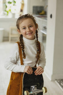 Girl holding skateboard - JOHF02004