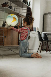 Girl looking at globe - JOHF02027