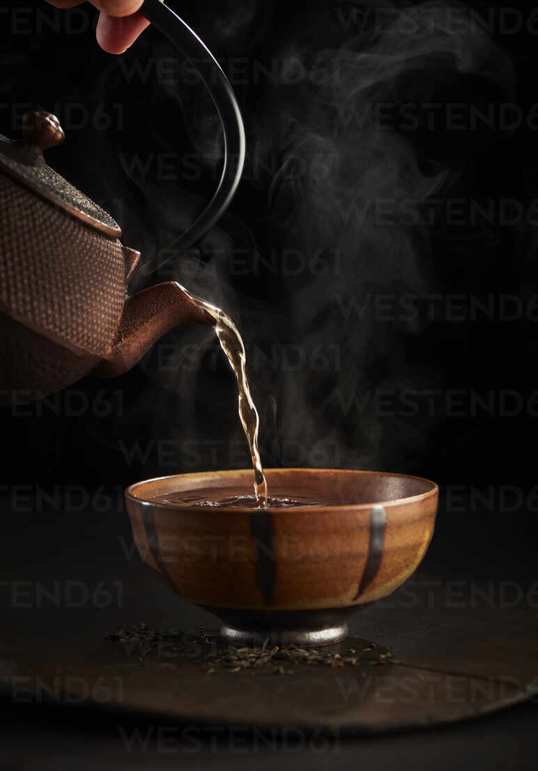 Close-up view of pouring hot tea from thermos into cup Stock Photo