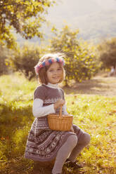 Portrait of a smiling young girl with hair wreath outdoors - XCF00261