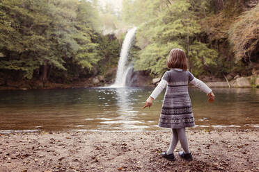 Young girl standing at a waterfall - XCF00263