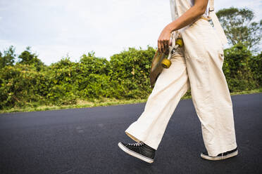 Young Woman Skateboarding in Summer - CAVF64440