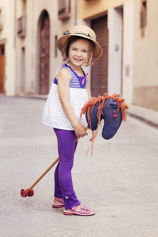 Portrait of little girl with hobby horse stock photo