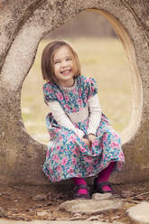 Portrait of laughing little girl wearing dress with floral design - XCF00270