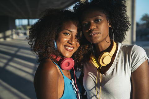 Portrait of two young women with headphones stock photo