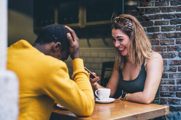Couple having fun in a coffee shop - CJMF00043