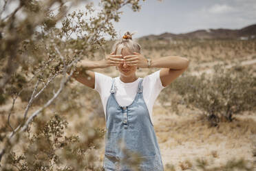 Junge Frau in Wüstenlandschaft, Joshua Tree National Park, Kalifornien, USA - LHPF01057