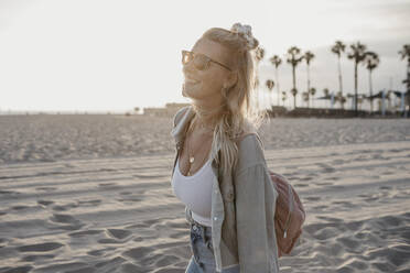Happy young woman on the beach, Venice Beach, California, USA - LHPF01060