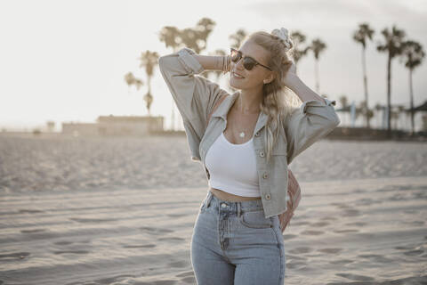 Glückliche junge Frau am Strand, Venice Beach, Kalifornien, USA, lizenzfreies Stockfoto