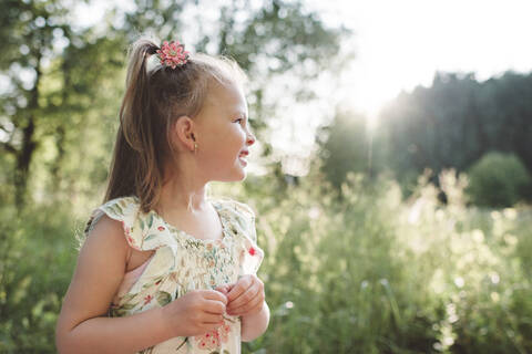 Smiling little girl in nature stock photo