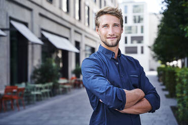 Portrait of confident young businessman in the city - PNEF02133