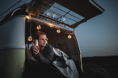 Portrait of woman with glass of white wine in van stock photo