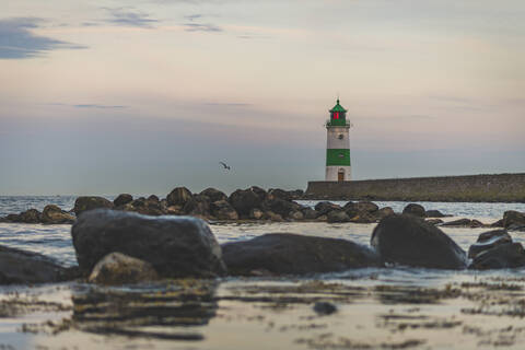 Germany, Schleswig-Holstein, Schleimunde lighthouse seen from coast at dusk stock photo