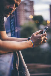 Man with pusera gay flag holding an smartphone - CJMF00072