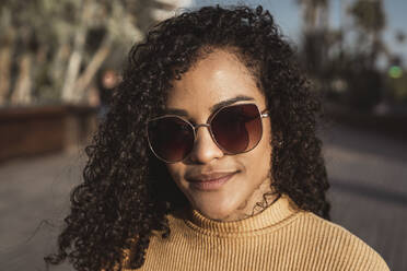 Porträt einer schönen Frau, die eine Sonnenbrille trägt - RCPF00013