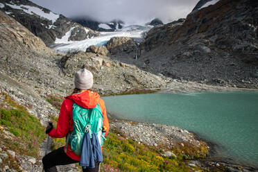 Rückansicht einer Wanderin gegen Gletscher und Berg - CAVF64839