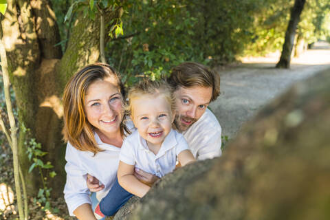 Portait of parents with little daughter in a park stock photo
