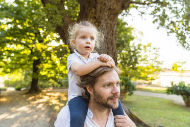 Father carrying little daughter on his shoulders - MGIF00780