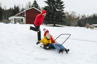 Mother with son on sleigh snow shovel - JOHF02235