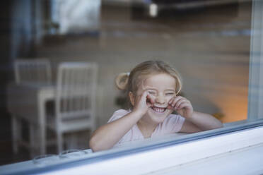 Girl looking through window - JOHF02248