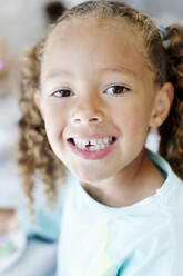 Portrait of girl with missing tooth - JOHF02447