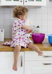 Girl mixing in bowl - JOHF02448