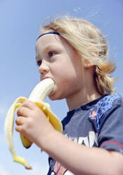 Boy eating banana - JOHF02490