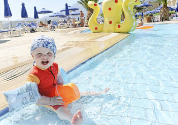 Baby girl in paddling pool - JOHF02493