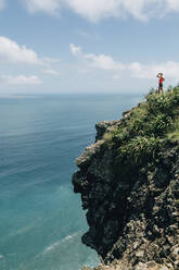 Woman on top of cliff - JOHF02573