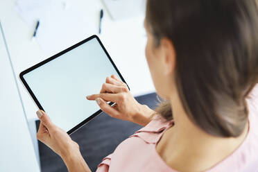 Overhead view of woman using tablet in office - BSZF01516