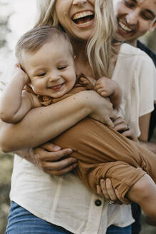 Glückliche Mutter, die ihren kleinen Sohn im Freien umarmt - LHPF01078