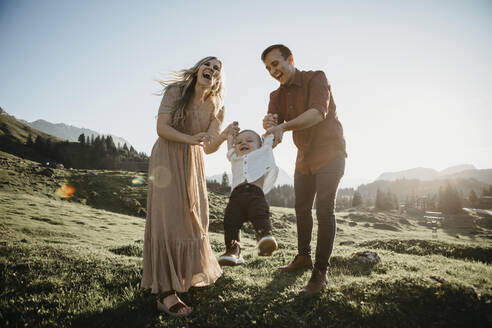 Happy family playing with little son on a hiking trip, Schwaegalp, Nesslau, Switzerland - LHPF01096