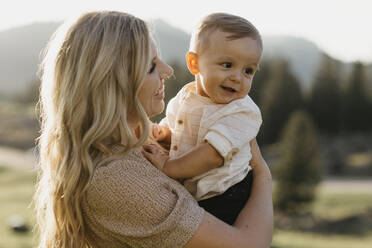 Mother holding her little son on a hiking trip, Schwaegalp, Nesslau, Switzerland - LHPF01097