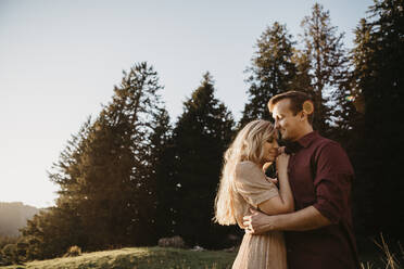 Affectionate young couple on a hiking trip at sunset, Schwaegalp, Nesslau, Switzerland - LHPF01116