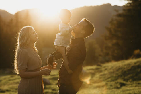 Happy family with little son on a hiking trip at sunset, Schwaegalp, Nesslau, Switzerland - LHPF01120