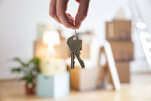 Close-up of woman holding house key in new home - MAMF00860