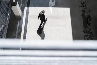 Top view of businessman with baggage on the go - DIGF08507