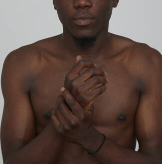 Portrait of African man, close-up of hands - PGCF00038