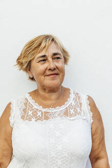 Portrait of a senior woman with a white wall background - MOSF00023