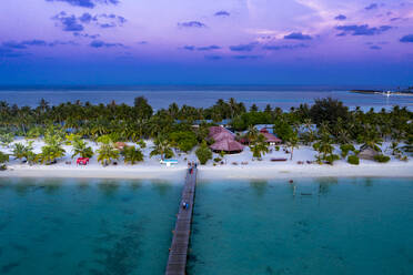 Maldives, Bodufinolhu, Aerial view of coastal tourist resort on South Male Atoll at dusk - AMF07336