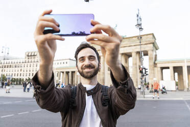 Man taking smartphone selfies, Berlin, Germany - WPEF02028