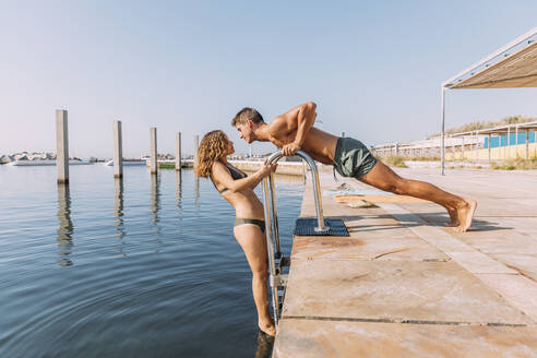 Young couple on a pier at the sea - MOSF00082