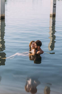 Affectionate young couple bathing in the sea - MOSF00086