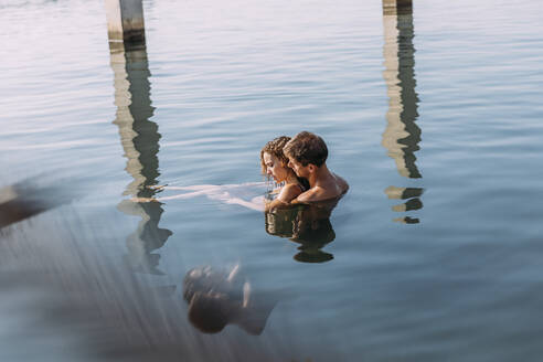 Affectionate young couple bathing in the sea - MOSF00087