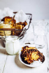 Jar of sour sauce and bowl of crunchy Jewish latkes - SBDF04059