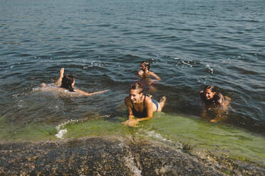 Freunde schwimmen im Meer - JOHF03323