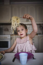 Smiling eating spaghetti - JOHF03470