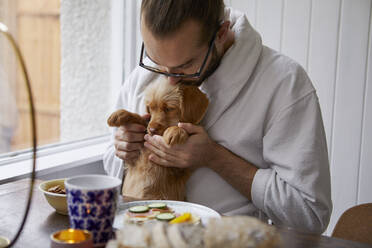 Man holding puppy - JOHF03495